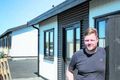 Verktaki Andri Leó Egilsson stendur við íbúð sem hann hefur lokið við.