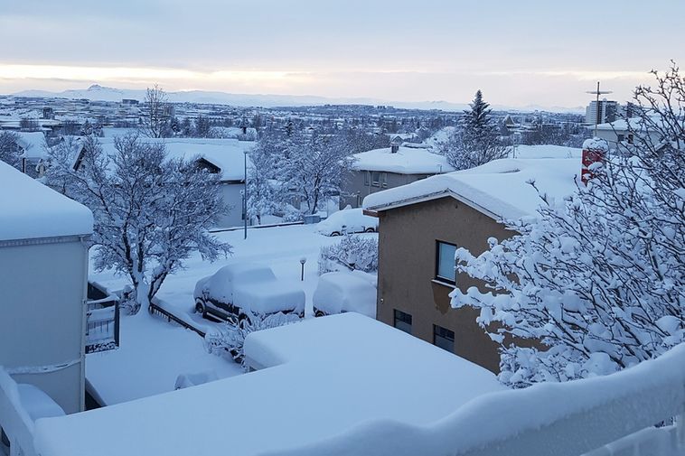 Pretty as a picture: the capital city in a thick coat of snow this morning.