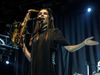 PJ Harvey dressed in black and wearing feathers on her head brandishing a saxofone at the Vodafone hall in Reykjavik last night.