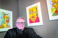 Listmálarinn Þórhallur Sigurðsson, Laddi, við nokkur verka sinna en hann opnar málverkasýningu á morgun.